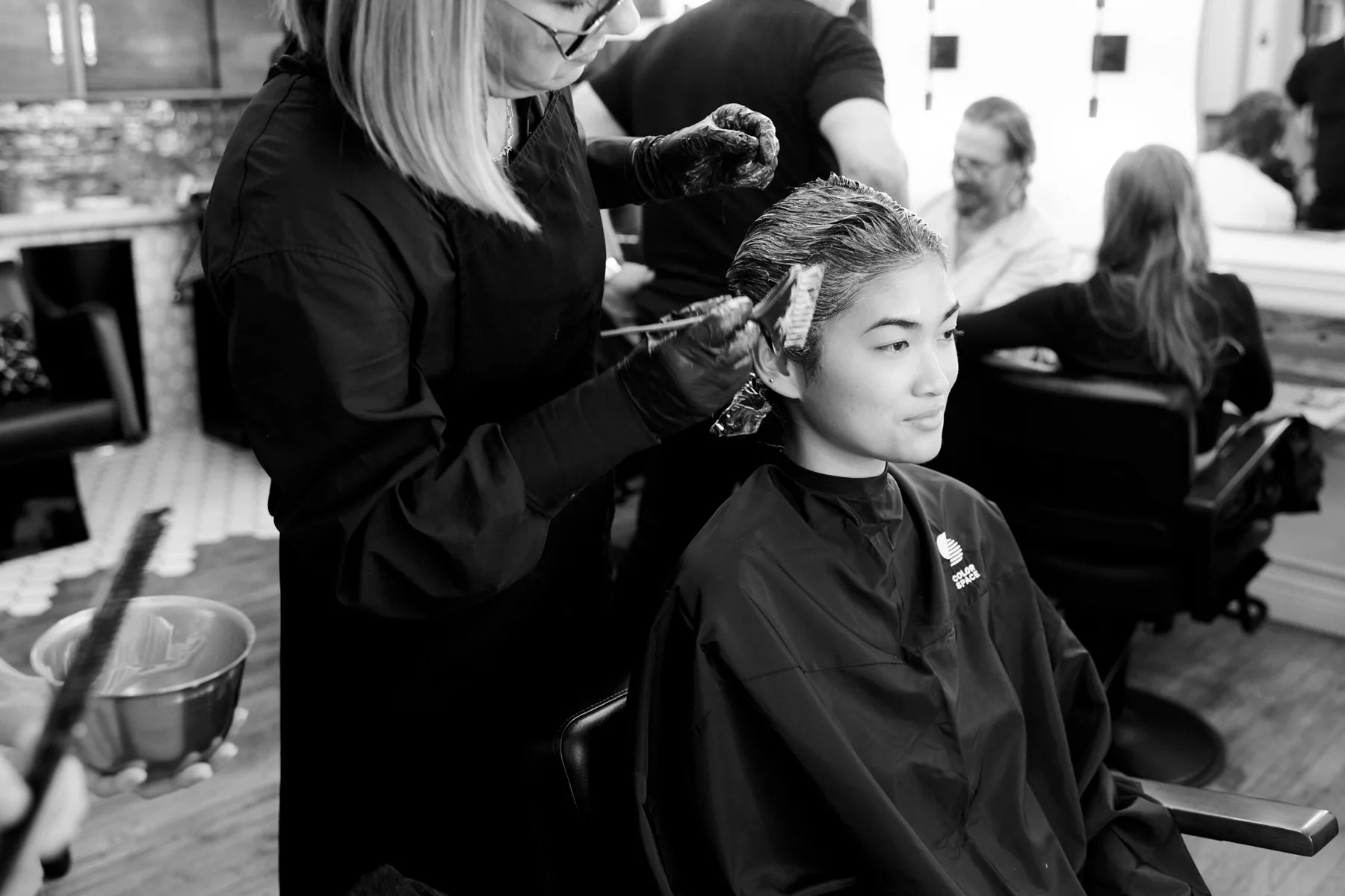 A colorist applying color at Frankie in Collingswood